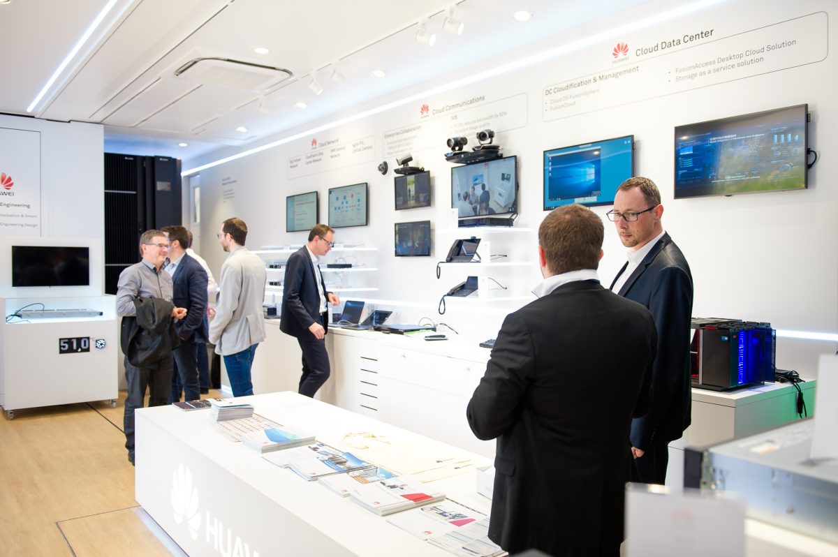 The Huawei France Tradeshow in the InfoVan 29 interior with guests and speakers product display