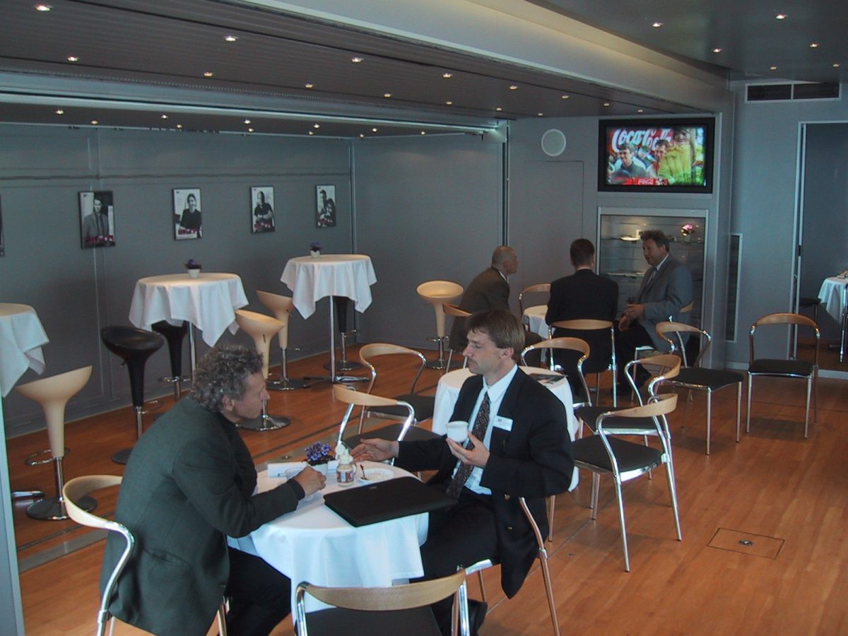 Interior of the InfoVan 12 while guests enjoy a drink