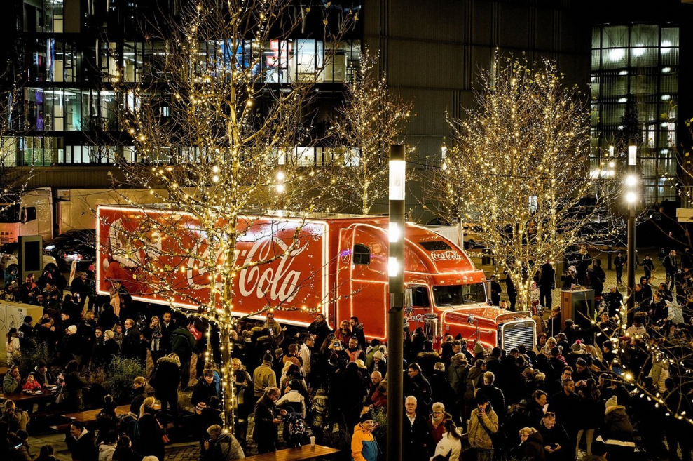 Coca-Cola Christmas Truck in Berlin during the holiday season in a city square with people around enjoying the event