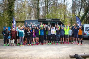The Saucony team in front of the "TAKE COURAGE" Saucony InfoWheels