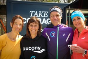 Smiling runners outside the Saucony "TAKE COURAGE" InfoWheels