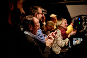 Happy and smiling guests at the Open TNO Essen event in Germany applauding the speaker,